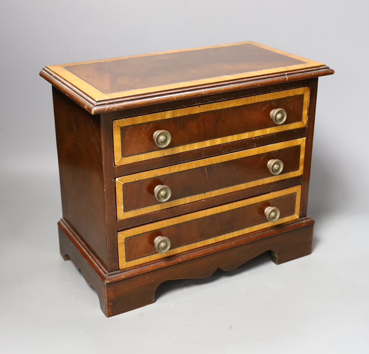 A miniature inlaid mahogany chest, 29cms wide x 25.5 cms high